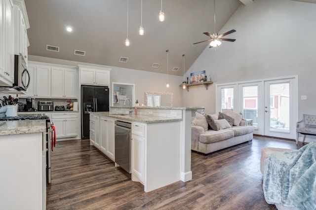 4902 Marshall St, Lubbock, TX 79416 - kitchen with stainless steel appliances, open floor plan, high vaulted ceiling, a ceiling fan, and white cabinets