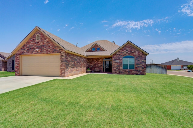 4902 Marshall St, Lubbock, TX 79416 - view of front of house featuring an attached garage, a front yard, brick siding, and concrete driveway
