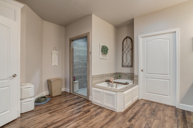 4902 Marshall St, Lubbock, TX 79416 - full bathroom featuring wood finished floors, a garden tub, and a shower