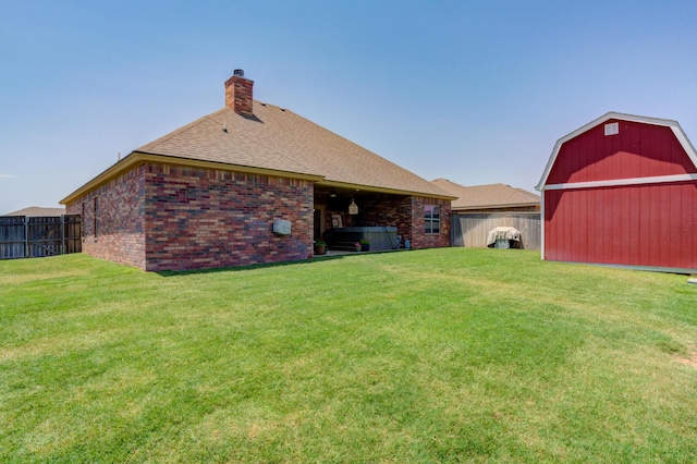 4902 Marshall St, Lubbock, TX 79416 - back of house featuring a barn, brick siding, a fenced backyard, a chimney, and roof with shingles