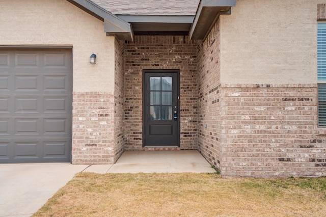 doorway to property with a garage