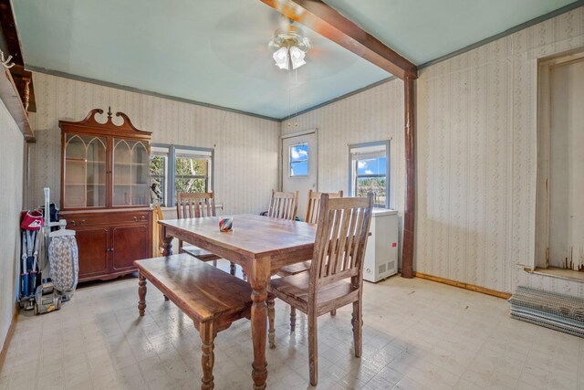 dining area with beam ceiling and ceiling fan