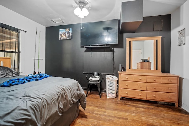 bedroom with wood-type flooring and ceiling fan