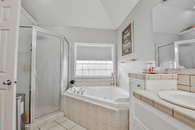 full bathroom featuring a stall shower, a textured ceiling, vanity, a tub with jets, and tile patterned floors