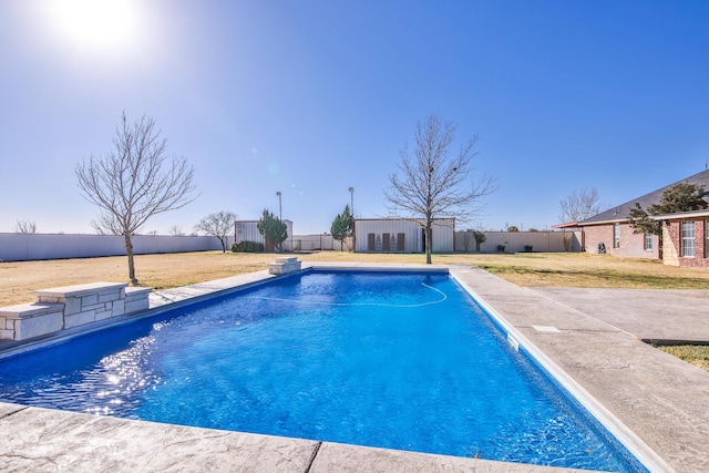 view of pool with a fenced in pool, a fenced backyard, a yard, and an outdoor structure