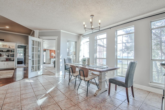 tiled dining room with baseboards, french doors, crown molding, a textured ceiling, and a notable chandelier