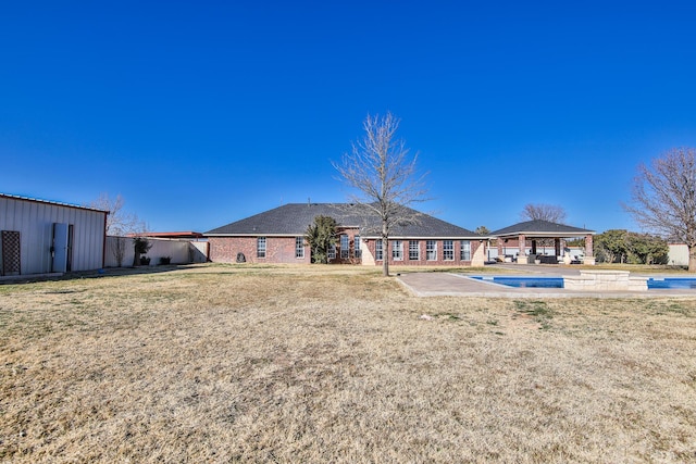 view of yard featuring an outbuilding, a gazebo, a patio area, and an outdoor pool