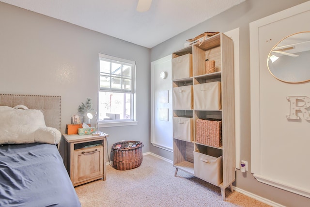 bedroom featuring a ceiling fan, light carpet, and baseboards