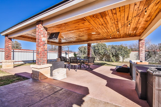 view of patio featuring outdoor dining area and a fenced backyard