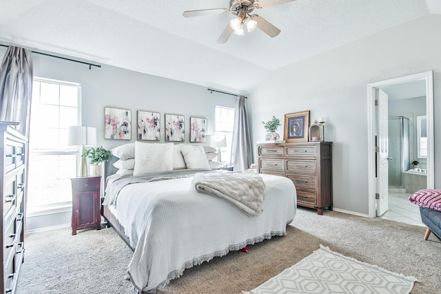 bedroom with light carpet, a ceiling fan, ensuite bath, vaulted ceiling, and a textured ceiling