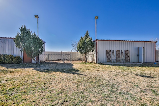 view of yard featuring an outbuilding and fence