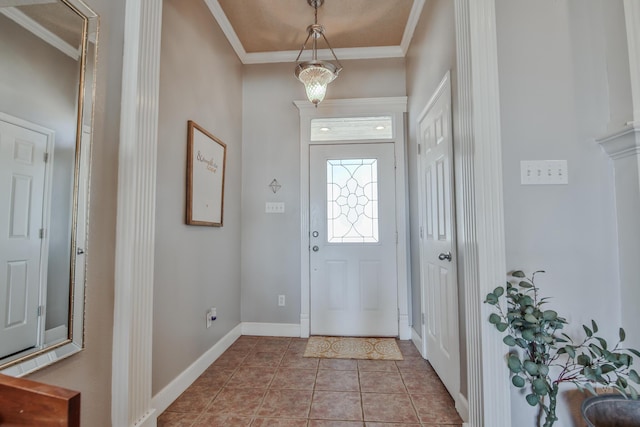 entrance foyer with ornamental molding, baseboards, and tile patterned floors