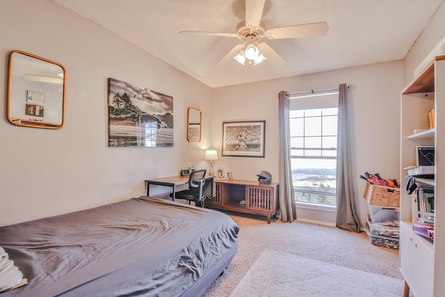 carpeted bedroom featuring a textured ceiling and a ceiling fan