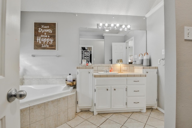 bathroom featuring ornamental molding, vanity, a bath, and tile patterned floors