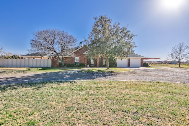 view of front of home featuring a garage, a front yard, fence, a carport, and driveway