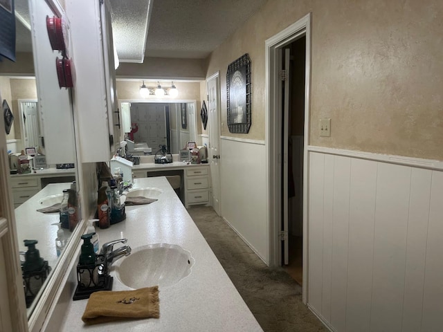 bathroom featuring sink and a textured ceiling