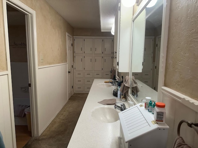 bathroom with vanity and a textured ceiling