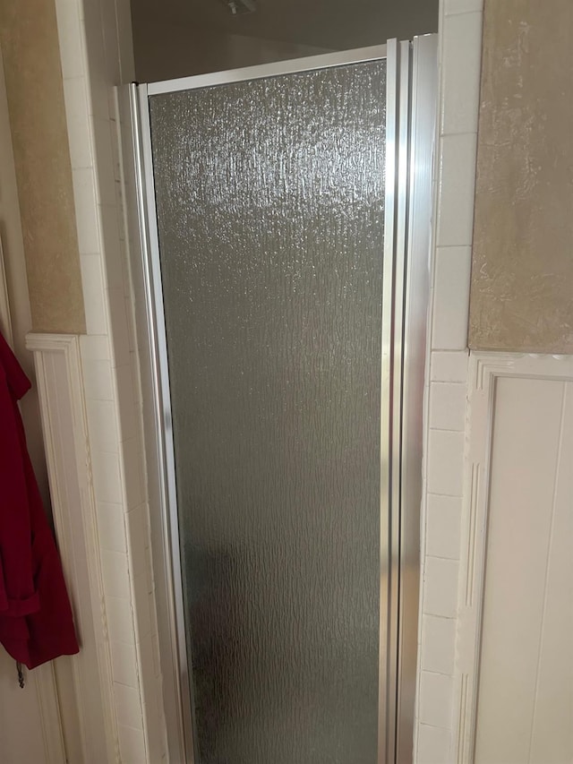 bathroom with a shower with door