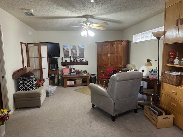 carpeted living room with a textured ceiling and ceiling fan