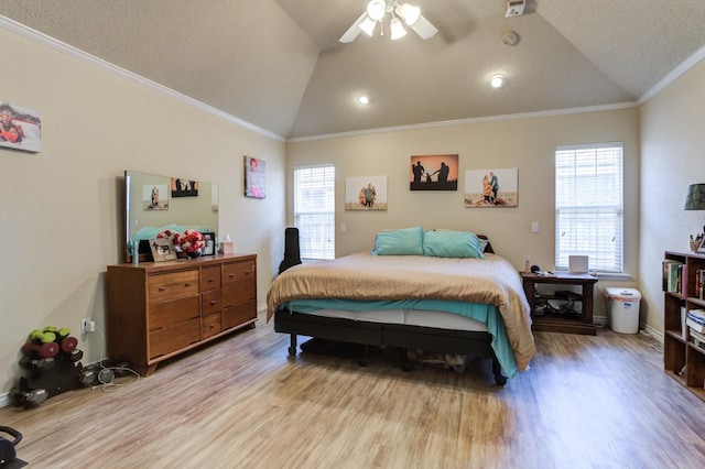 bedroom featuring multiple windows, vaulted ceiling, ornamental molding, and light wood-type flooring