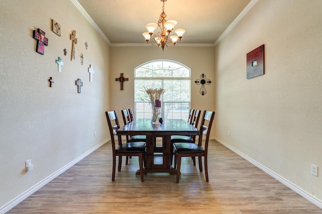 dining area with hardwood / wood-style flooring, ornamental molding, and a chandelier