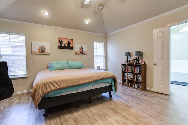 bedroom featuring ornamental molding, vaulted ceiling, and light hardwood / wood-style floors