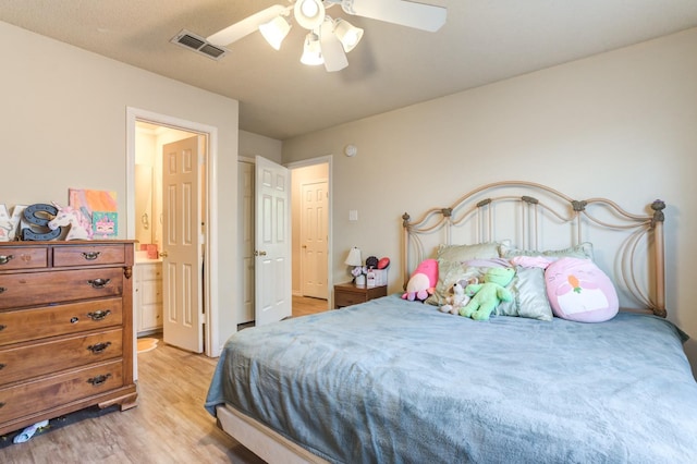 bedroom with ensuite bath, light hardwood / wood-style flooring, and ceiling fan