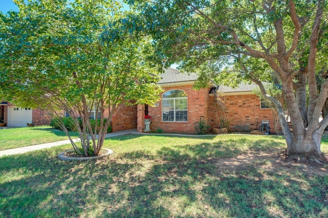 view of property hidden behind natural elements featuring a front lawn