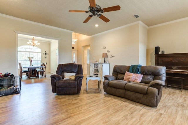 living room featuring ceiling fan, ornamental molding, and light wood-type flooring