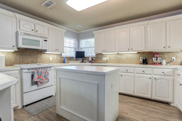 kitchen with white cabinetry, a center island, white appliances, and light hardwood / wood-style flooring