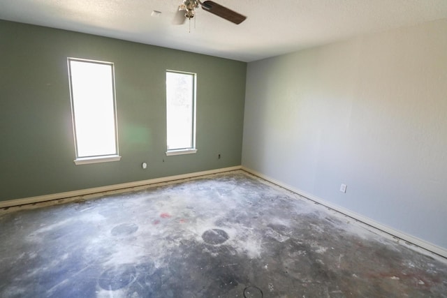 unfurnished room featuring a textured ceiling, concrete floors, and ceiling fan