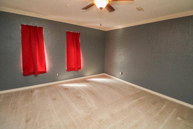 carpeted spare room with ornamental molding and ceiling fan