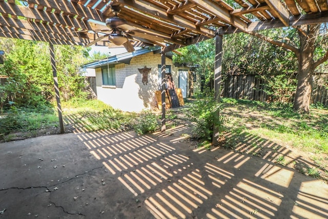 view of patio featuring ceiling fan and a pergola