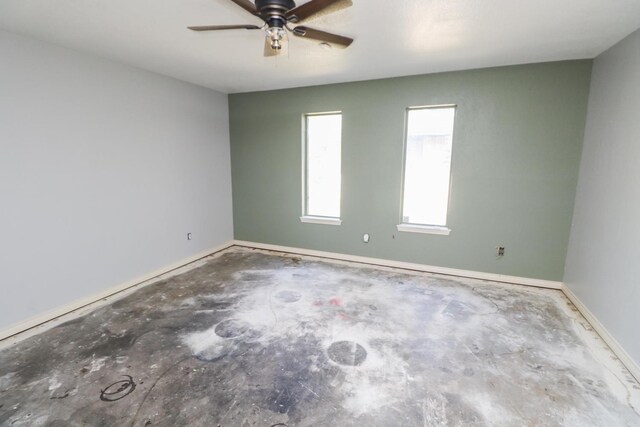 spare room with concrete floors and ceiling fan