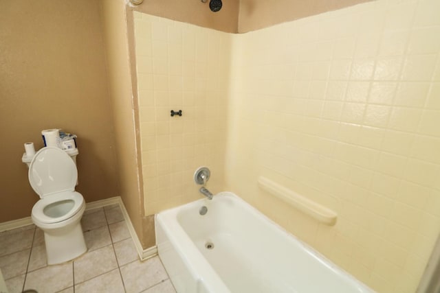 bathroom featuring tile patterned flooring, tiled shower / bath combo, and toilet