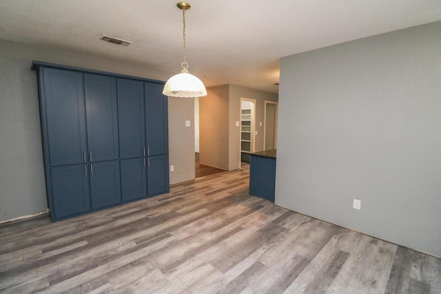 unfurnished dining area with wood-type flooring