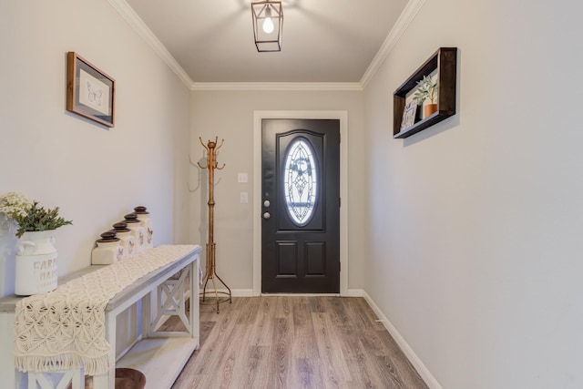 foyer entrance featuring crown molding, baseboards, and light wood-style floors
