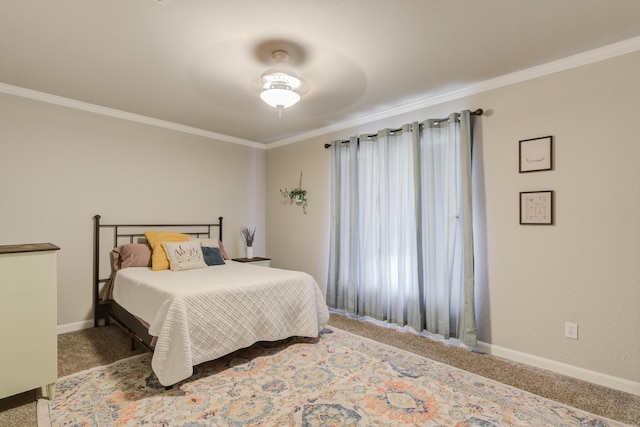 carpeted bedroom with baseboards, ornamental molding, and ceiling fan