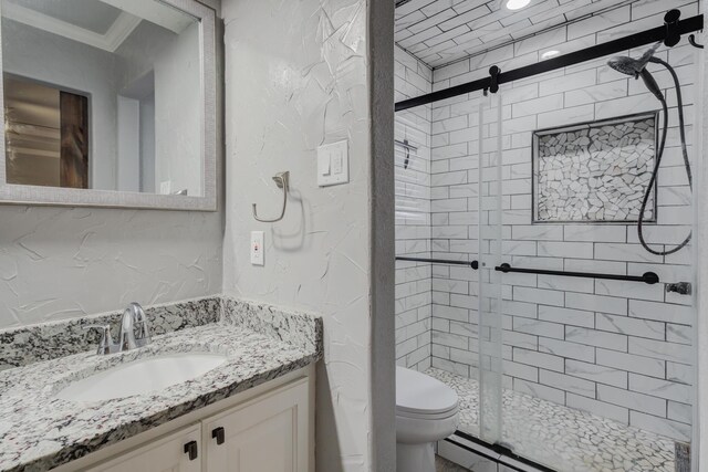 bathroom with a shower stall, crown molding, a textured wall, toilet, and vanity