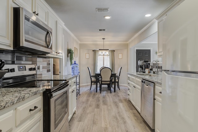 kitchen featuring white cabinetry, visible vents, appliances with stainless steel finishes, and a sink