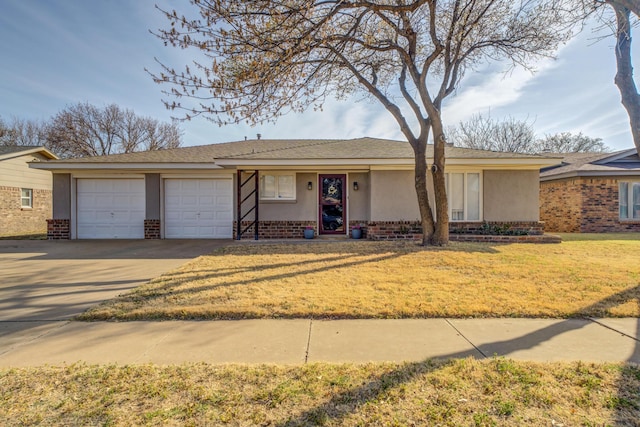 ranch-style home featuring driveway, a front yard, an attached garage, stucco siding, and brick siding