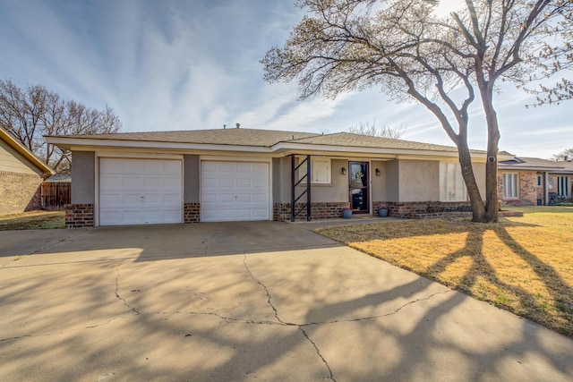 ranch-style house with driveway, a garage, stucco siding, and brick siding