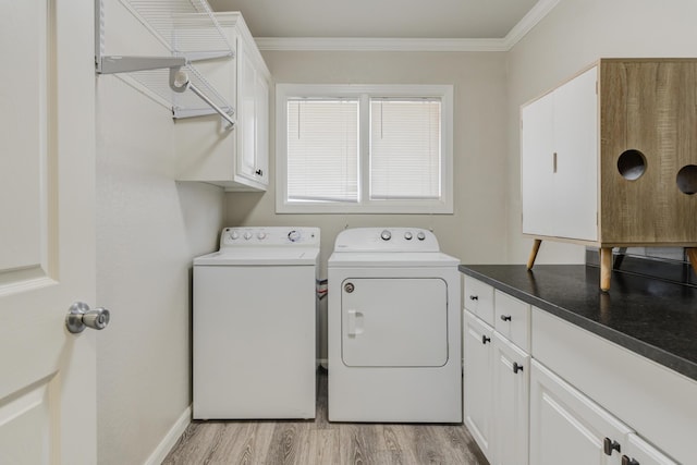 washroom with cabinet space, crown molding, light wood finished floors, and independent washer and dryer