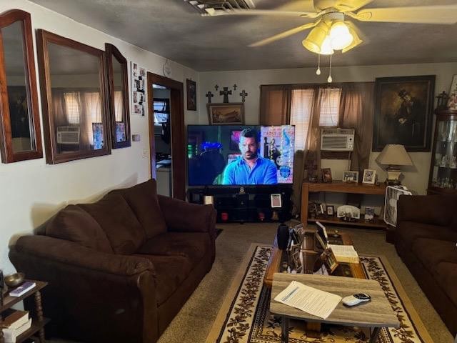 carpeted living room featuring cooling unit and ceiling fan