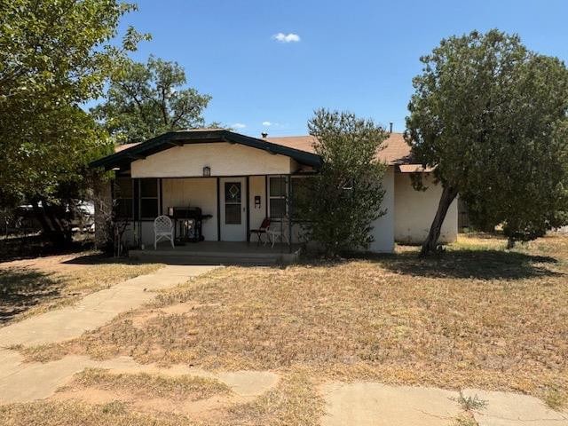 view of front of house with a porch and a front yard