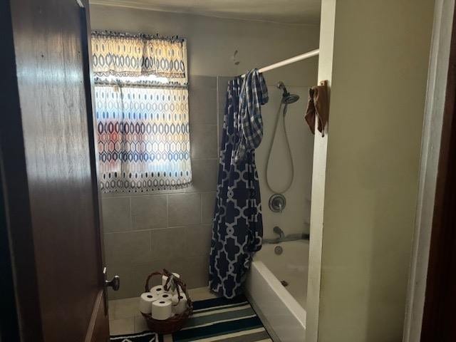 bathroom with shower / bath combo with shower curtain