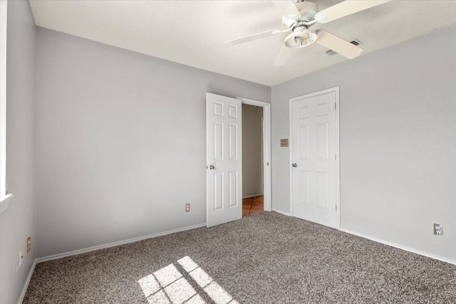 spare room with carpet floors and ceiling fan