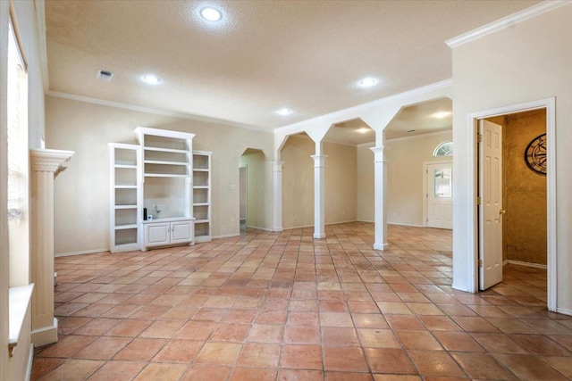 unfurnished living room featuring ornate columns, light tile patterned flooring, and crown molding