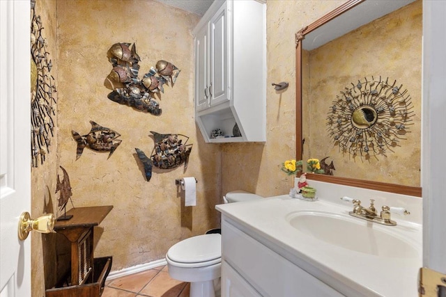 bathroom featuring tile patterned flooring, vanity, and toilet