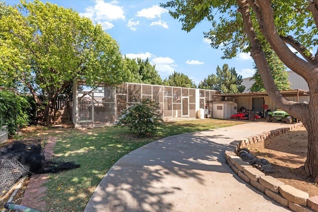 view of front facade featuring a front yard and a storage unit